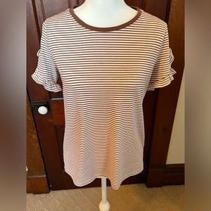 Brown and cream colored t-shirt with ruffled sleeves.
